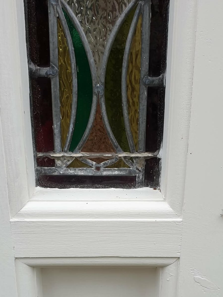 The same door with the rail spliced with new timber and repainted, the original stained glass untouched