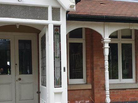 The restored porch and front door of a Victorian house