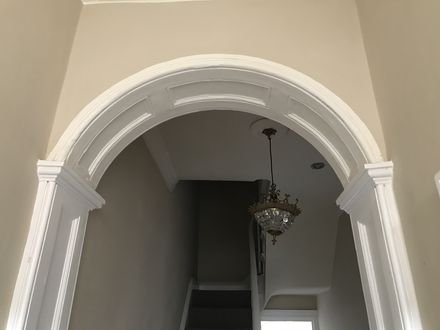 A restored plaster archway between period hallways