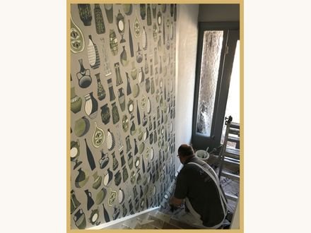 Before and after: a hallway hung with a bold patterned paper